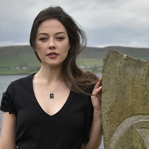 Model wearing Heritage necklace with Dingle Bay in the background 